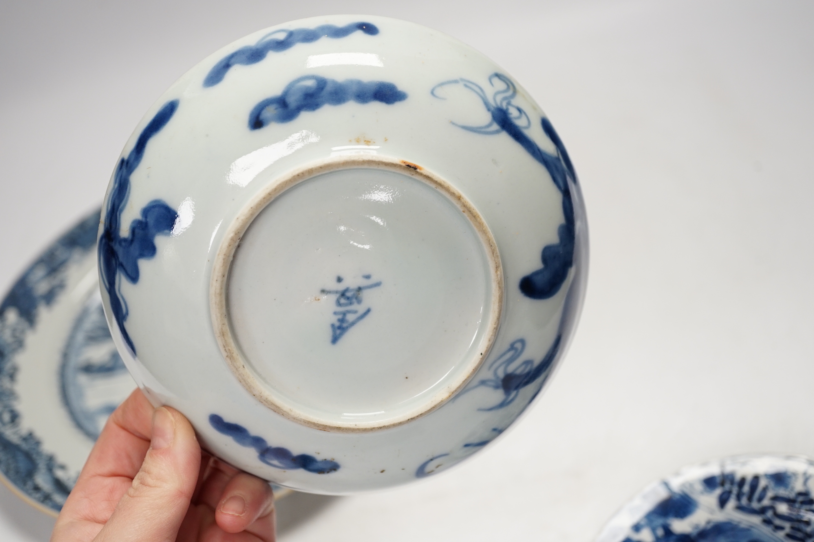 An 18th century Chinese export blue and white dish together with two others, largest 26cm